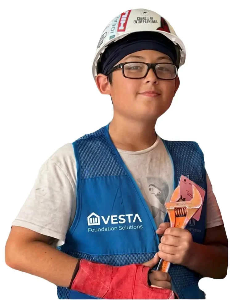 Vesta Foundation Solutions intern holding orange wrench